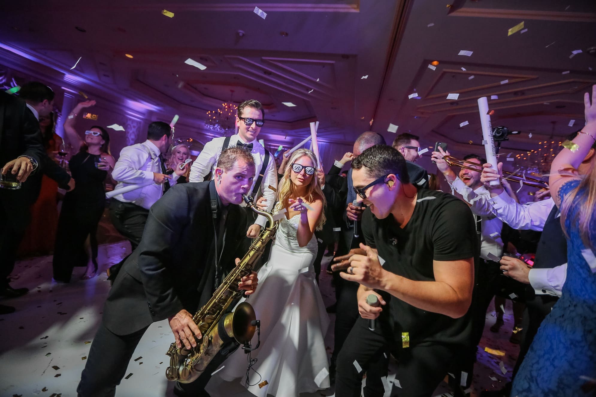 The Headliners sax player and singer on a packed dance floor with the bride